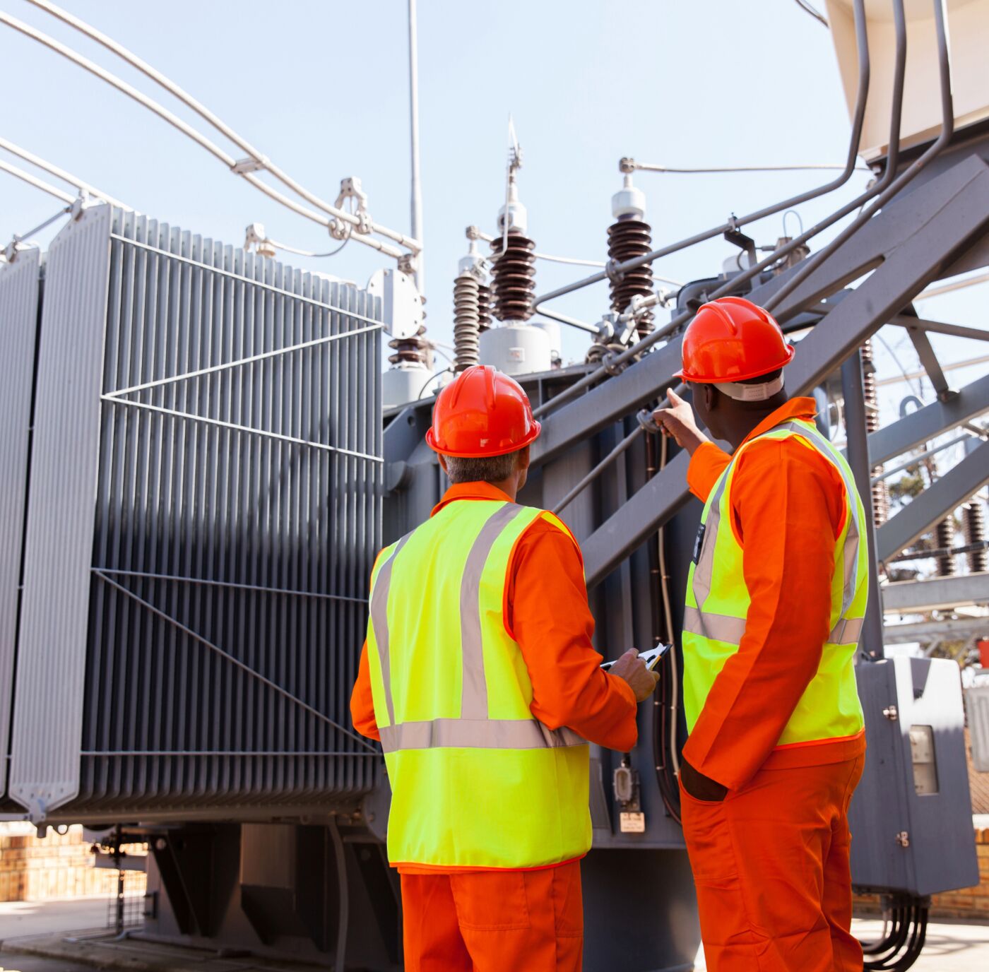Engineers inspecting a power transformer