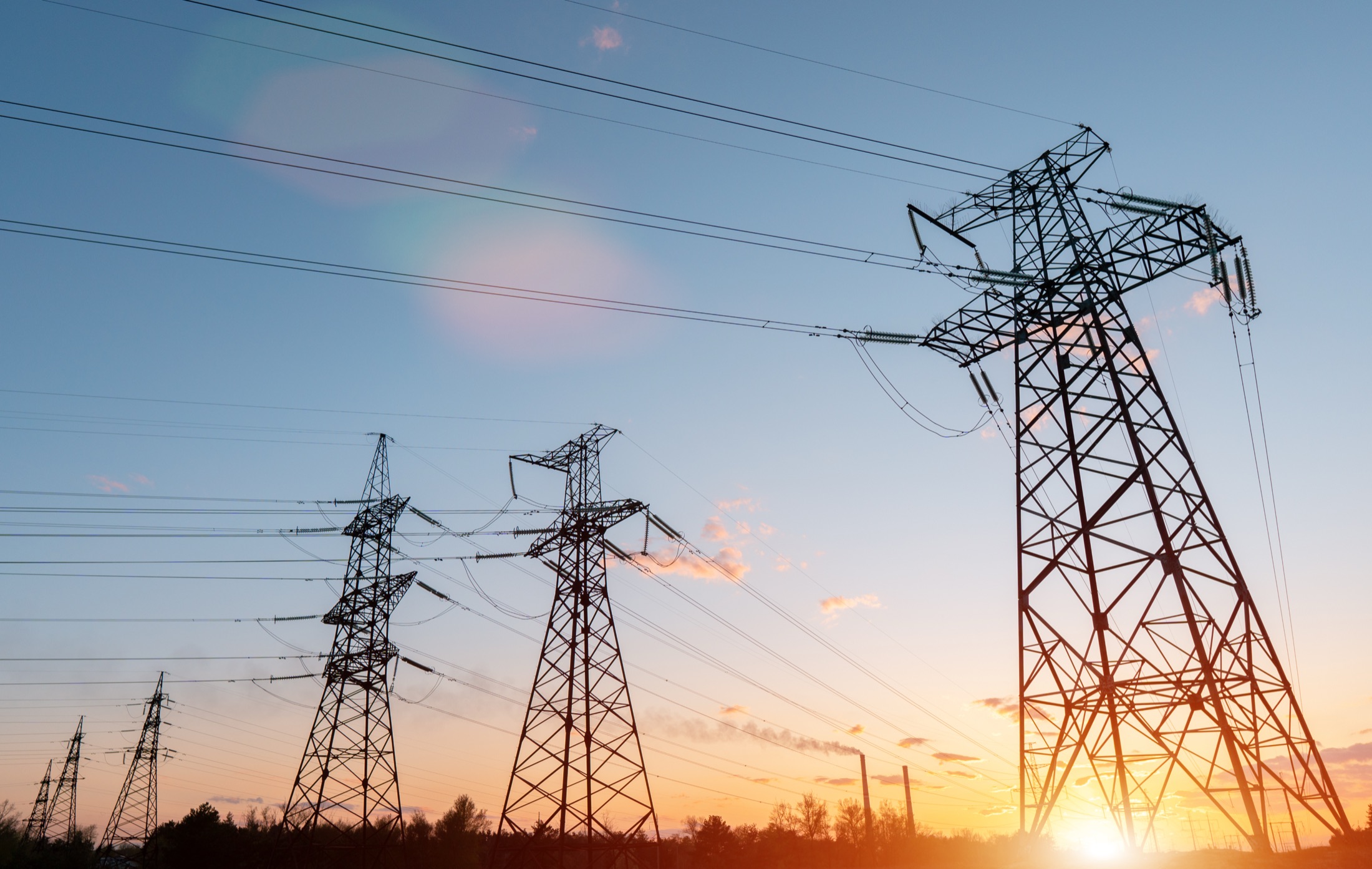 High-voltage electrical transmission towers at dusk in Dar es Salaam